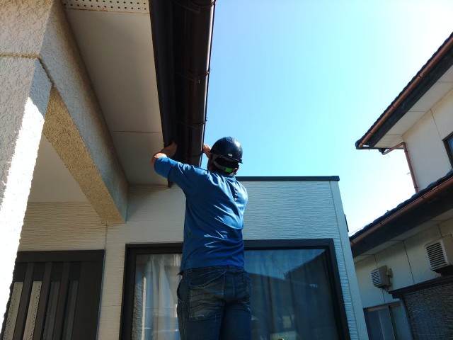 金具を調整して雨樋の勾配調整をしているところ