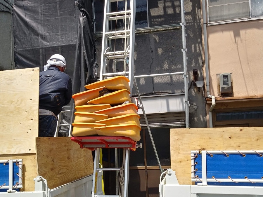 梯子を使用して廃材を運び出しています