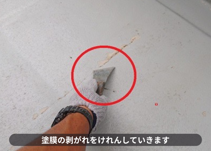 バルコニーの塗膜の剥がれをケレンしている様子