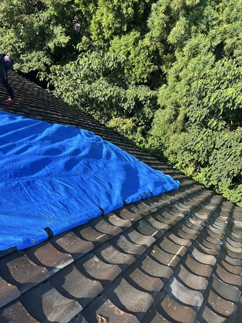 雨漏りした瓦屋根にブルーシートで養生